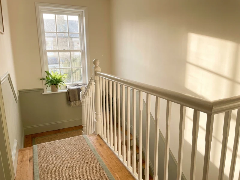 Sunlit, freshly cleaned staircase and landing in a Derby home